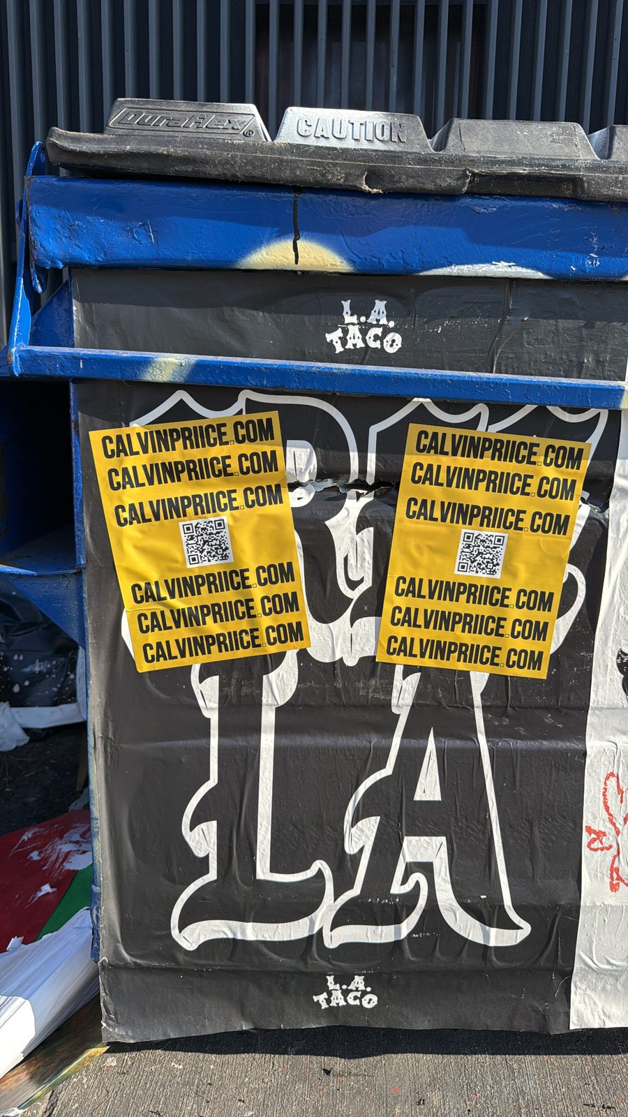 Yellow CALVINPRIICE.COM QR stickers pasted on an LA Taco street-art dumpster