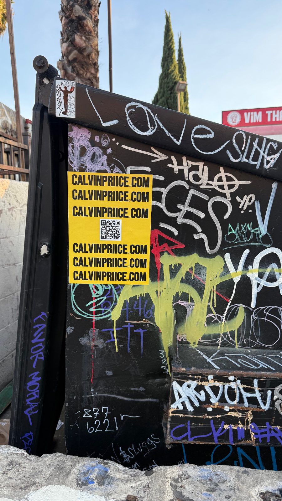 CALVINPRIICE.COM sticker on a graffiti-covered electrical box in LA