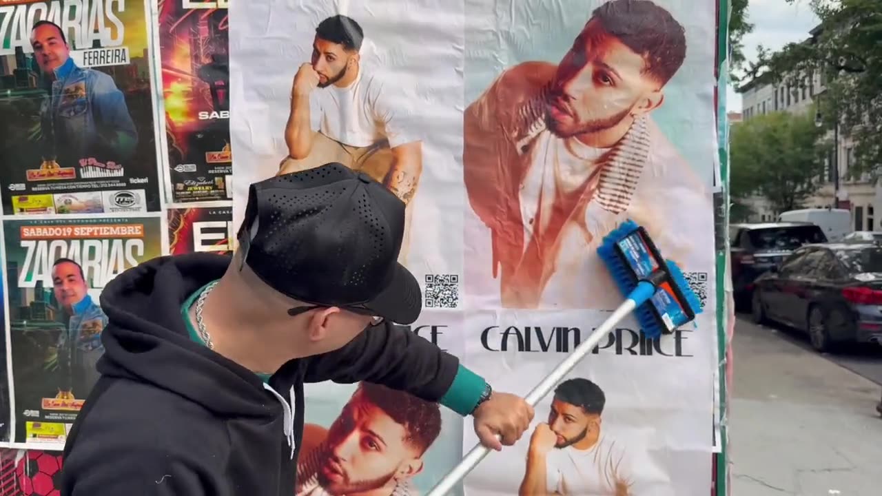 Calvin Priice posters being wheatpasted onto a wall in New York City