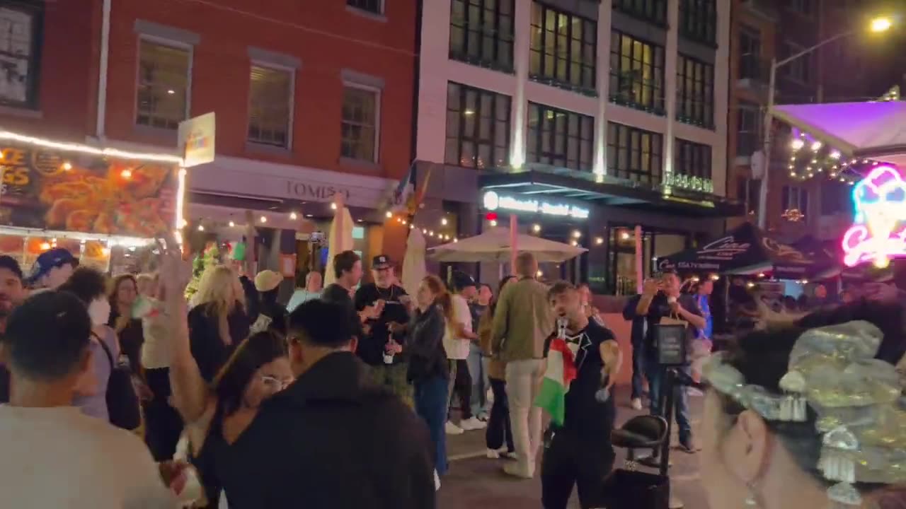 Crowds on Mulberry Street at night during the Feast of San Gennaro in Little Italy